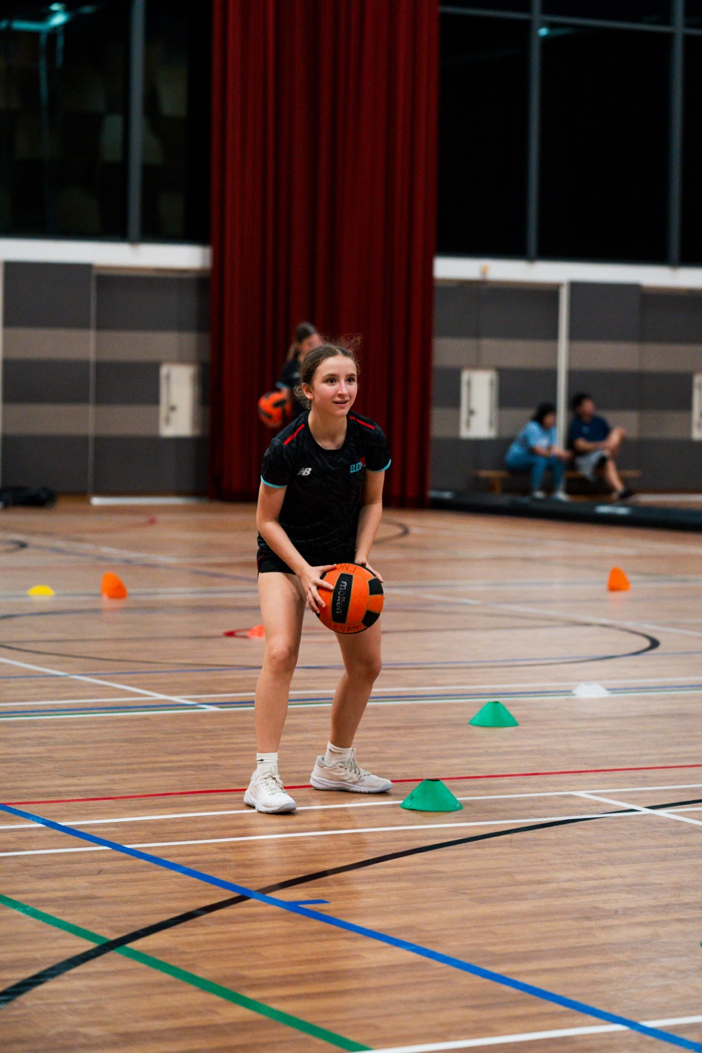 Elevate player practising with a netball