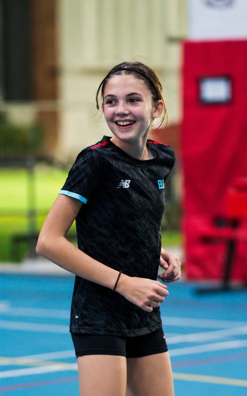Elevate player smiling during netball training